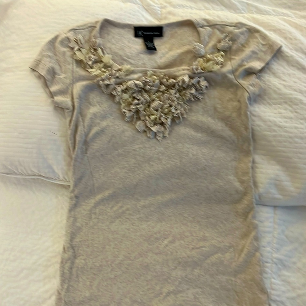 Oatmeal women’s T-shirt with interesting detail at the neck.